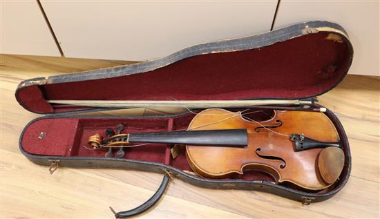An early 20th century violin, bears label Paolo Fiorini, Taurini 1928, cased with a bow, single-piece back 36cm